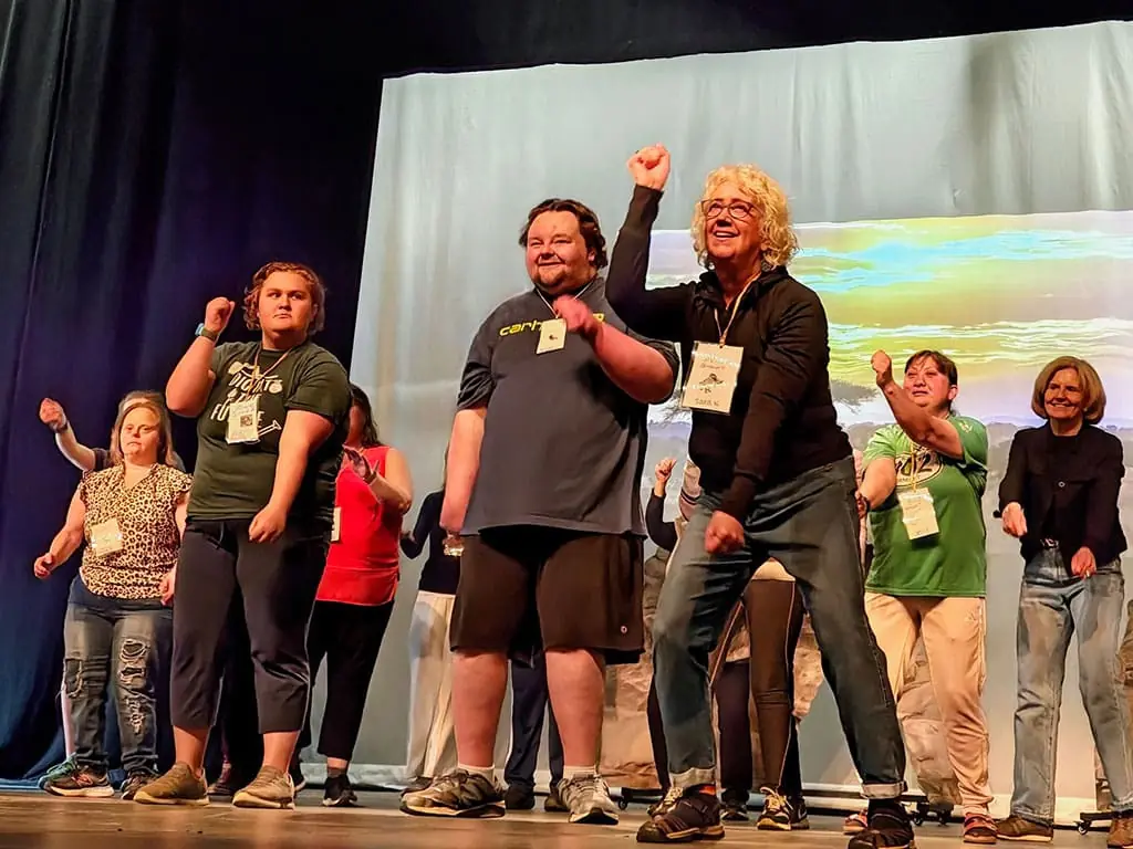 Participants performing a dance on stage at the Town Hall Theatre