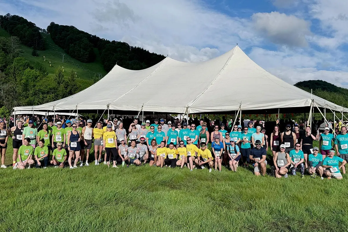 Hundreds of Covered Bridges Half Marathon runners gathered in front of a large tent