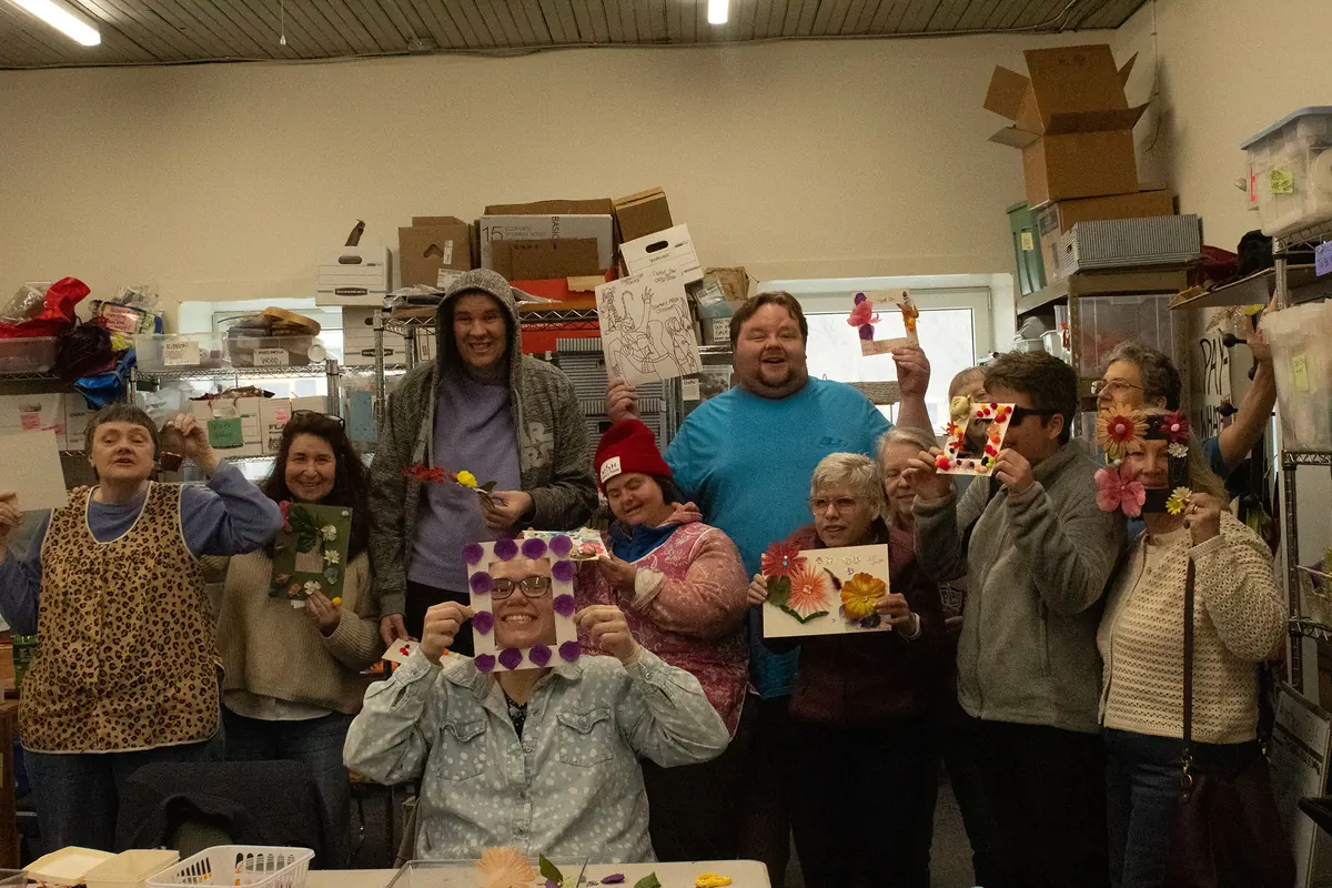 A group of participants proudly holding up the artwork they made