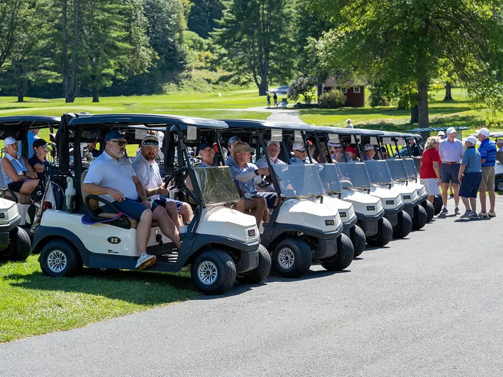 A long row of golf carts lined up for the shotgun start