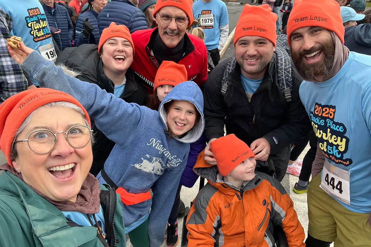 Smiling Turkey Trot runners in matching orange hats